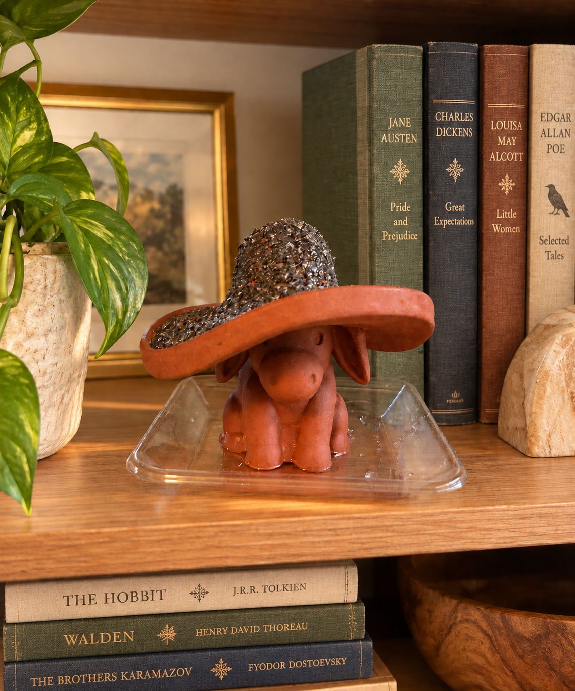 Terracotta donkey planter with dry chia seeds spread across the sombrero, before germination