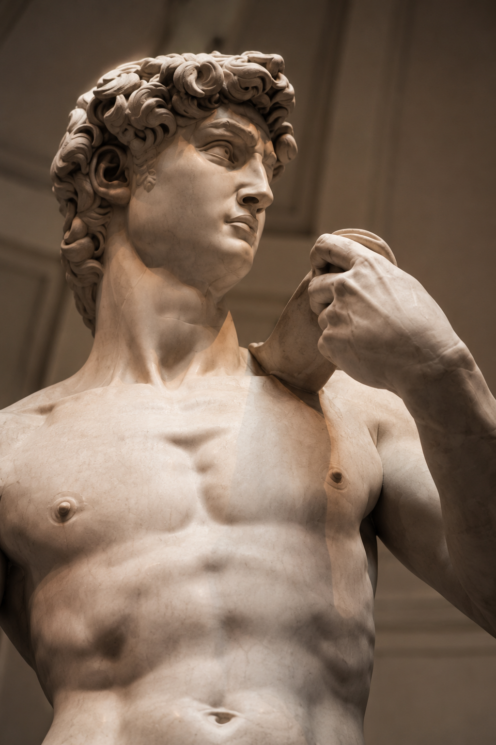 Low-angle close-up of Michelangelo's David — veins, muscles, and quiet resolve in marble